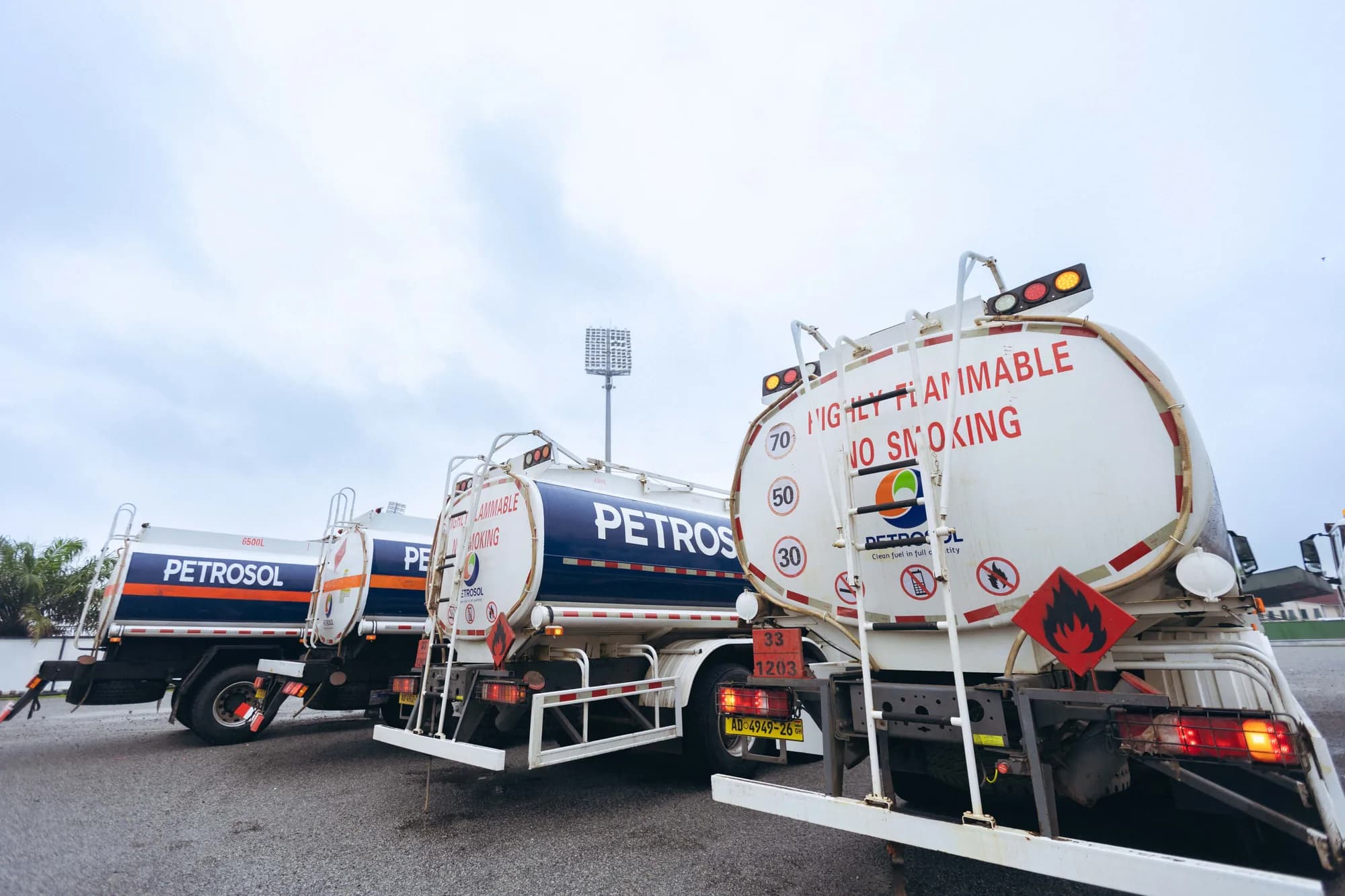 Three PETROSOL road tankers parked in line, marked “clean fuel in full quantity” and carrying flammable-load hazard plates